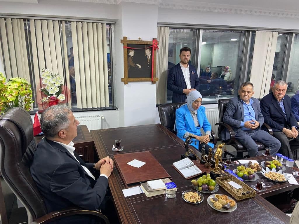 Guests seated across the desk during a visit to an official’s office