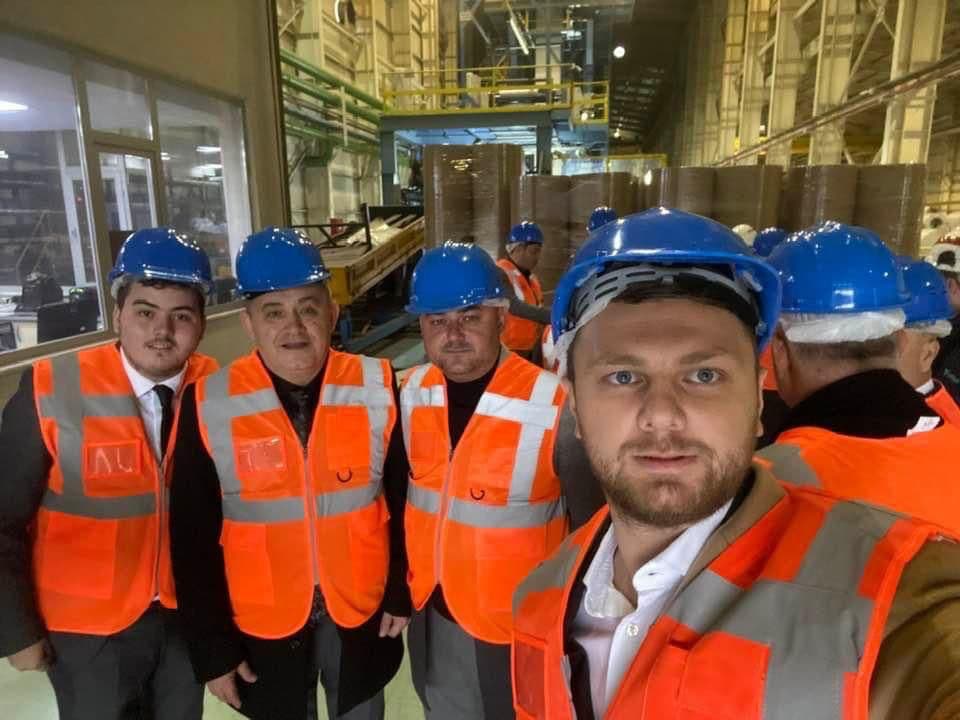 Ömer Yazıcıoğlu and a delegation in hard hats and hi-vis vests during a factory visit