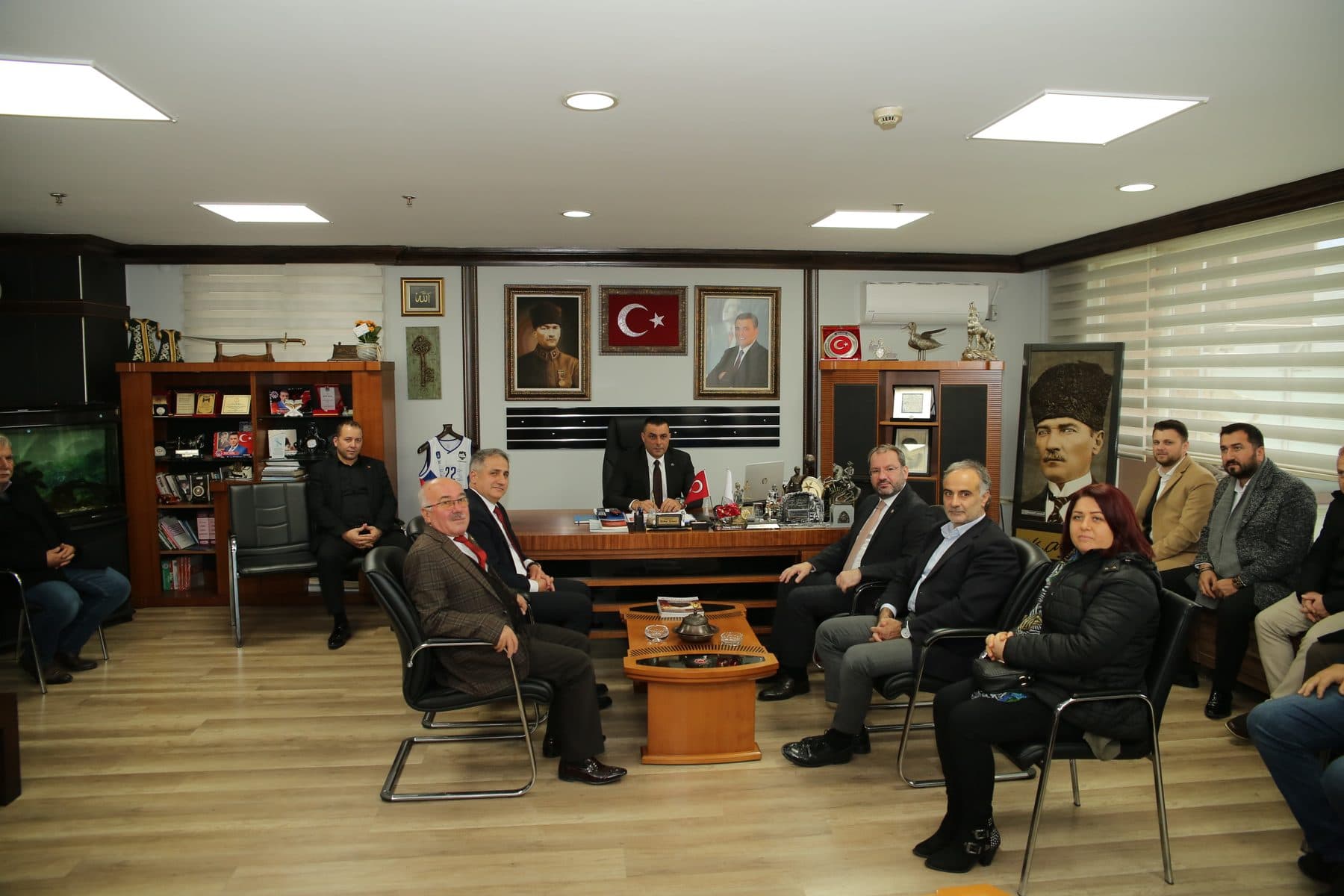 Board members and guests gathered around a table at an association’s premises