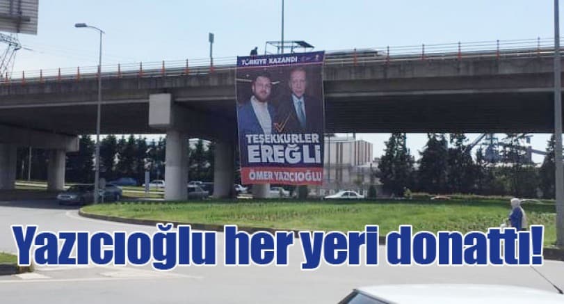 Congratulatory banner on a bridge at the city entrance, with the road below